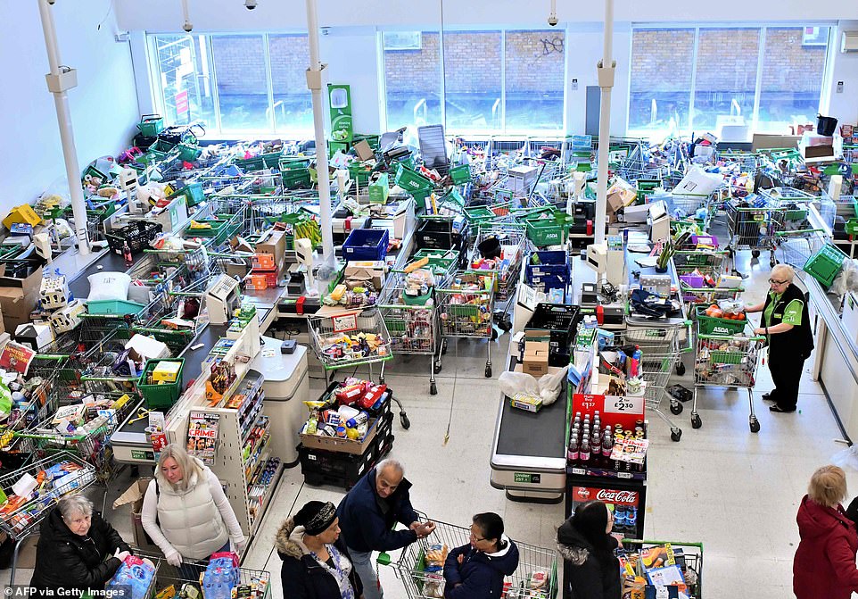 25978502-8113007-Trolleys_piled_high_for_delivery_are_seen_as_shoppers_queue_at_t-m-102_1584234871874.jpg