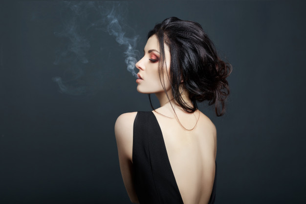 brunette-woman-smoking-dark-background_91497-1128.jpg